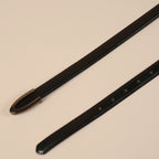 Darci belt strap and open U buckle laid diagonally