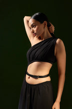 Woman posing in a black one-shoulder outfit with the Darci belt