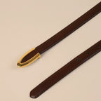 Darci brown belt strap and gold U buckle laid diagonally