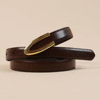 Close-up of the Darci belt's polished gold U buckle on brown leather