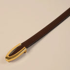 Close-up of the Darci gold buckle on brown leather