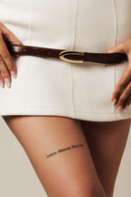 Brown Darci belt worn with a white mini dress
