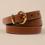 Close-up of the Georgia belt's rounded gold buckle and white stitching