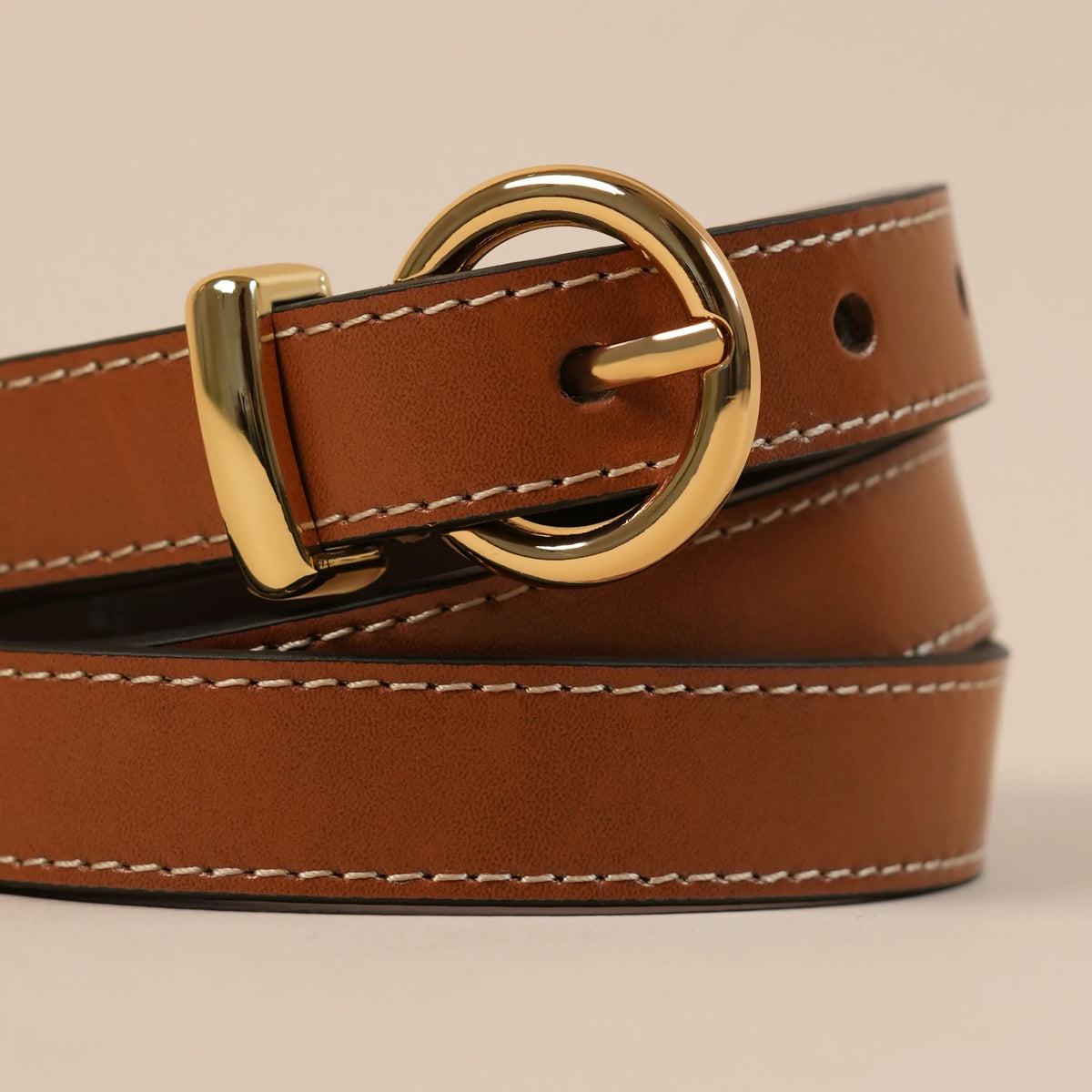 Close-up of contrast edge stitching on the tan Georgia belt