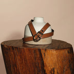 Georgia belt draped over a ceramic bust on a wooden stump