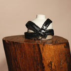 Rio belt draped over a ceramic bust on a wooden stump