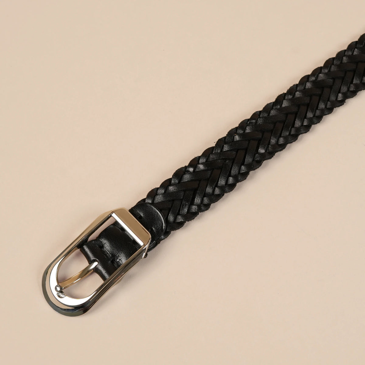Close-up of the Rio belt's silver buckle on black braided leather