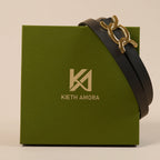 Scarlett black belt draped over the olive Kieth Amora gift box