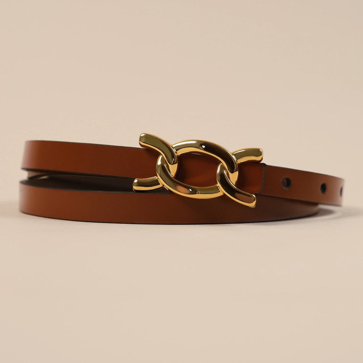 Close-up of the Scarlett belt's gold chain-link buckle on brown leather