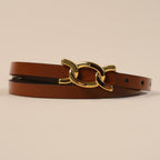 Close-up of the Scarlett belt's gold chain-link buckle on brown leather