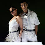 Couple posing in white, man wearing the black Croco belt with linen trousers