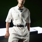 Man in white linen shirt and trousers wearing the black Croco belt
