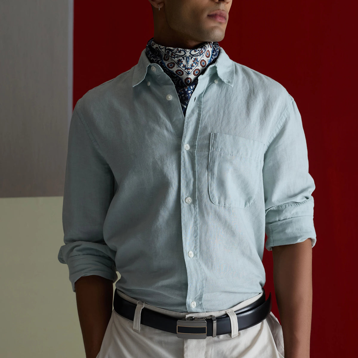 Man in a light blue shirt and paisley scarf wearing the Black Outlaw belt