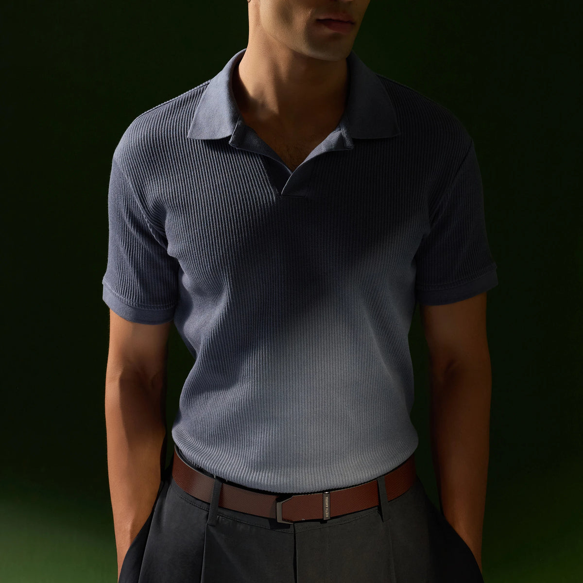 Man in a blue polo and dark trousers wearing the Brown Kensington belt