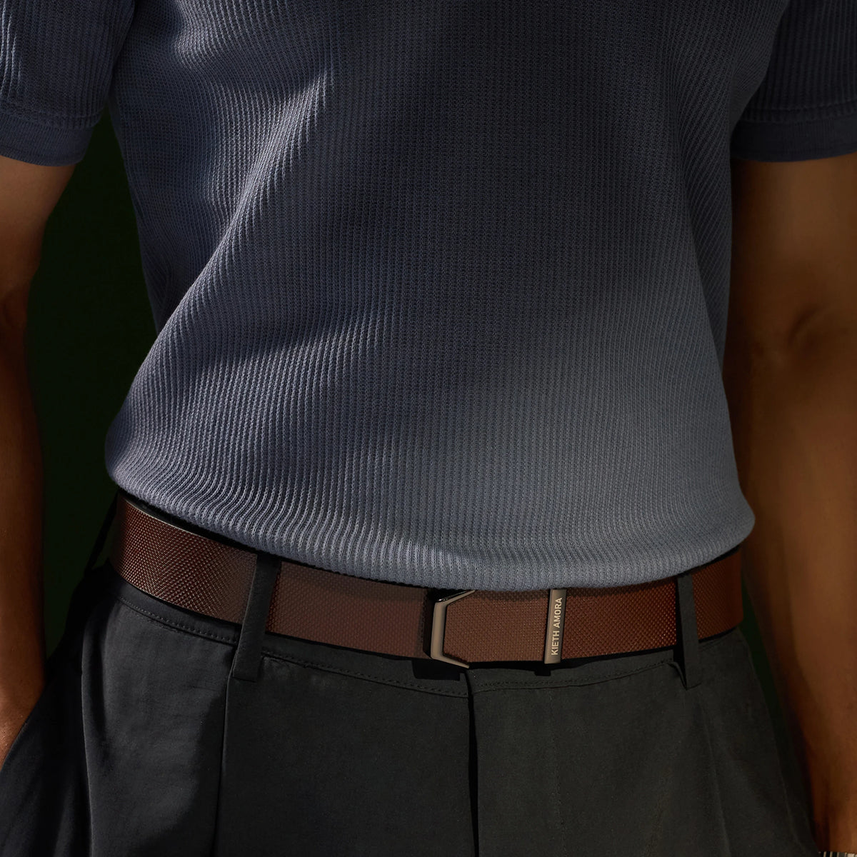 Brown Kensington belt worn with a grey knit top and charcoal trousers