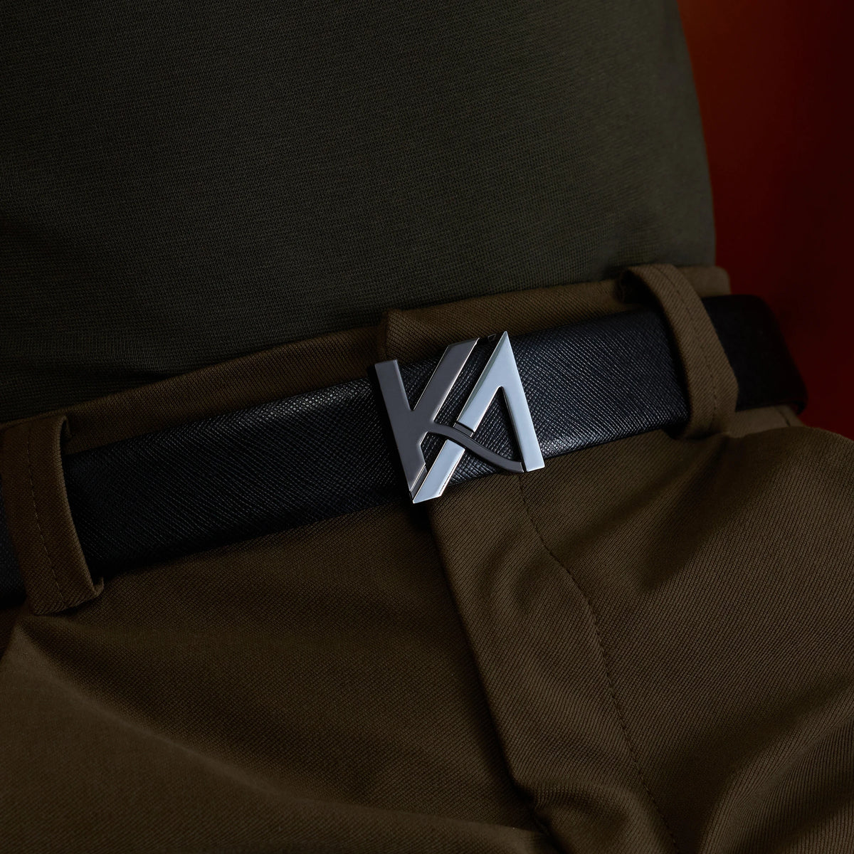 The OG Belt with KA monogram buckle worn with olive trousers